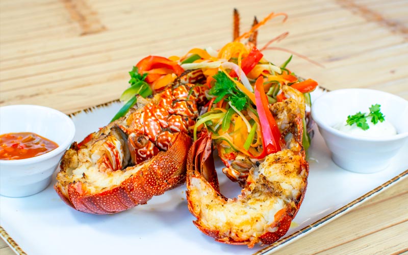PalmBeach Tropical Restaurant | Grilled Spiny Lobster (price per 100 grams) | spiny lobster grilled over natural charcoal and served with Creole sauce, price per 100 grams (min. 500g)