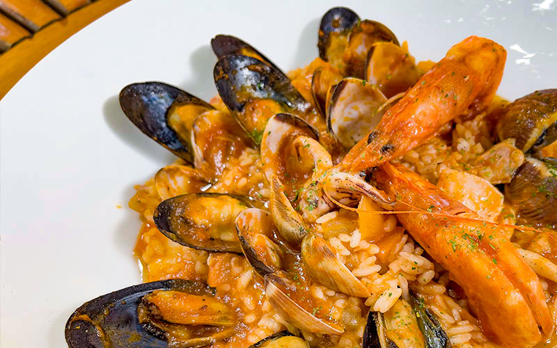 PalmBeach Tropical Restaurant | Seafood Risotto | carnaroli rice cooked in our fish broth, with seafood, with two tomatoes, extra virgin olive oil and parsley